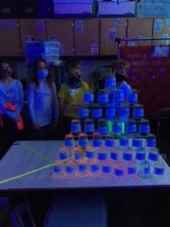 We stacked cups with sight words that glowed.