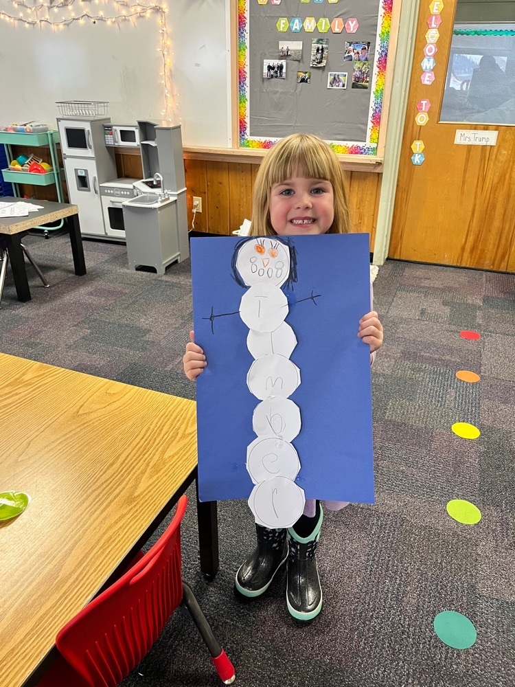 Timber shows off her completed snowman